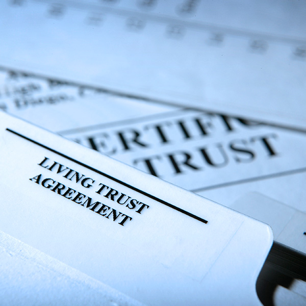 A close up of a notebook tab identified as a living trust agreement